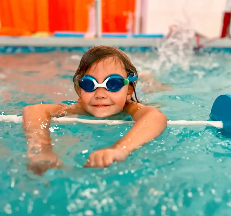 Private Lessons- programs Swimmers puts on a goggles in swimming pool